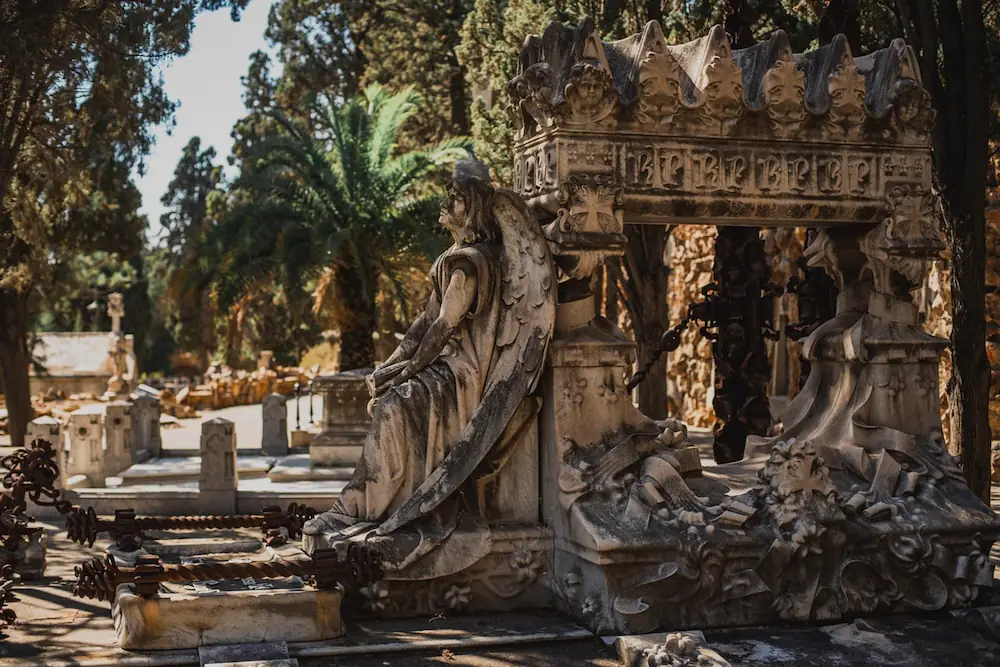 Funeral monument adorned with statues at the Montjuïc Cemetery in Barcelona.