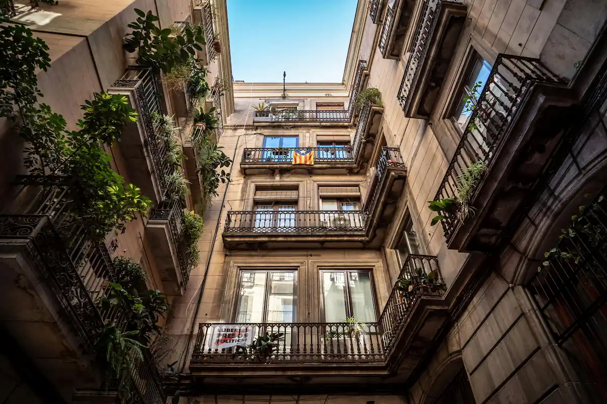 Flower-filled balconies on a typical building in Barcelona.