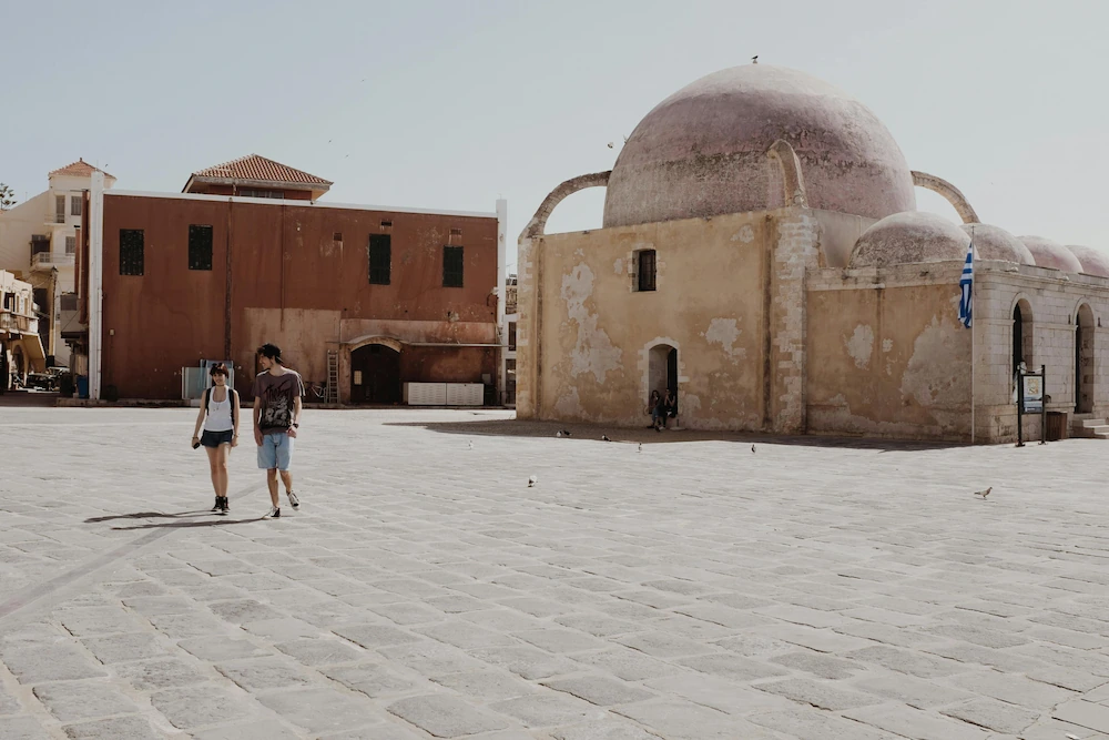 Travelers from our book club exploring a historic square in Crete.