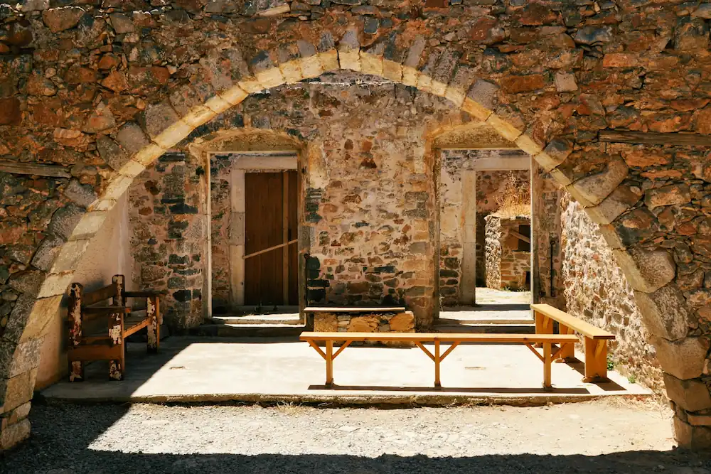 Historical site with a stone wall in Crete, an ideal place for a literary debate.